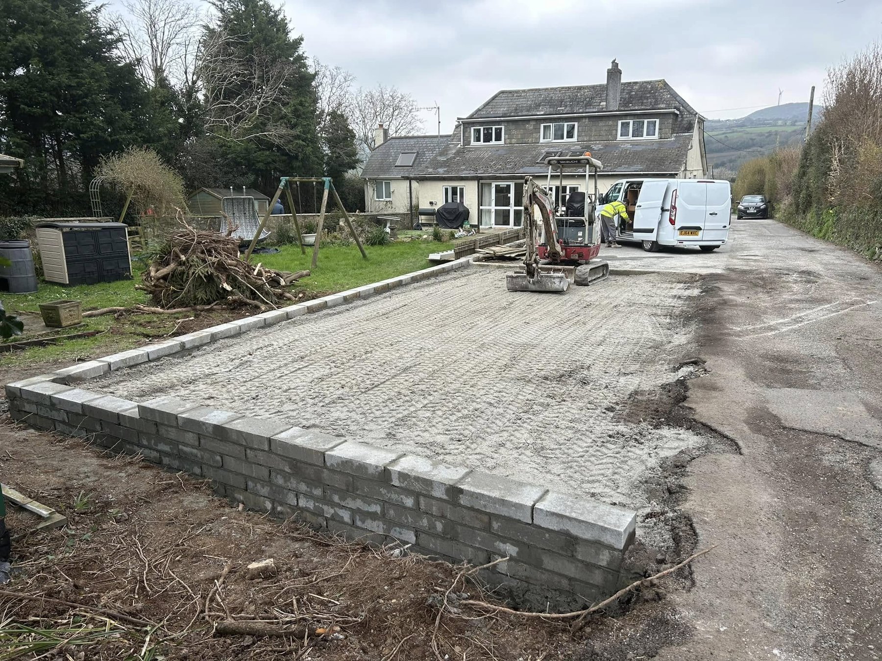 Groundworks foundation slab and retaining wall ready for build, Cornish cottage backdrop